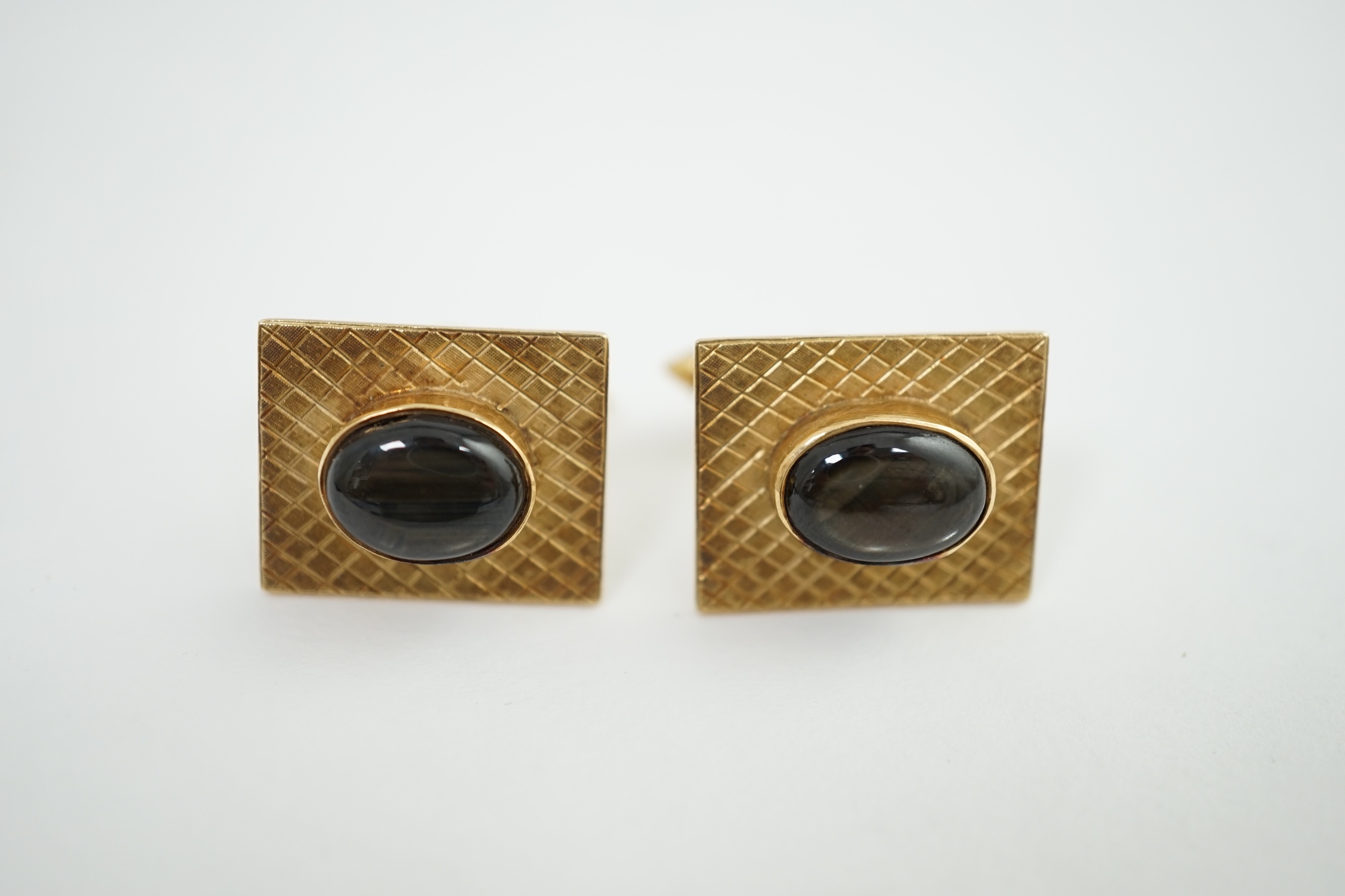 A pair of 18K gold tablet cufflinks, mounted with grey quartz cabochons, in a rubover setting